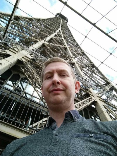 Chris Stanley, with some kind of crazy Bridge Builder-object in the background.